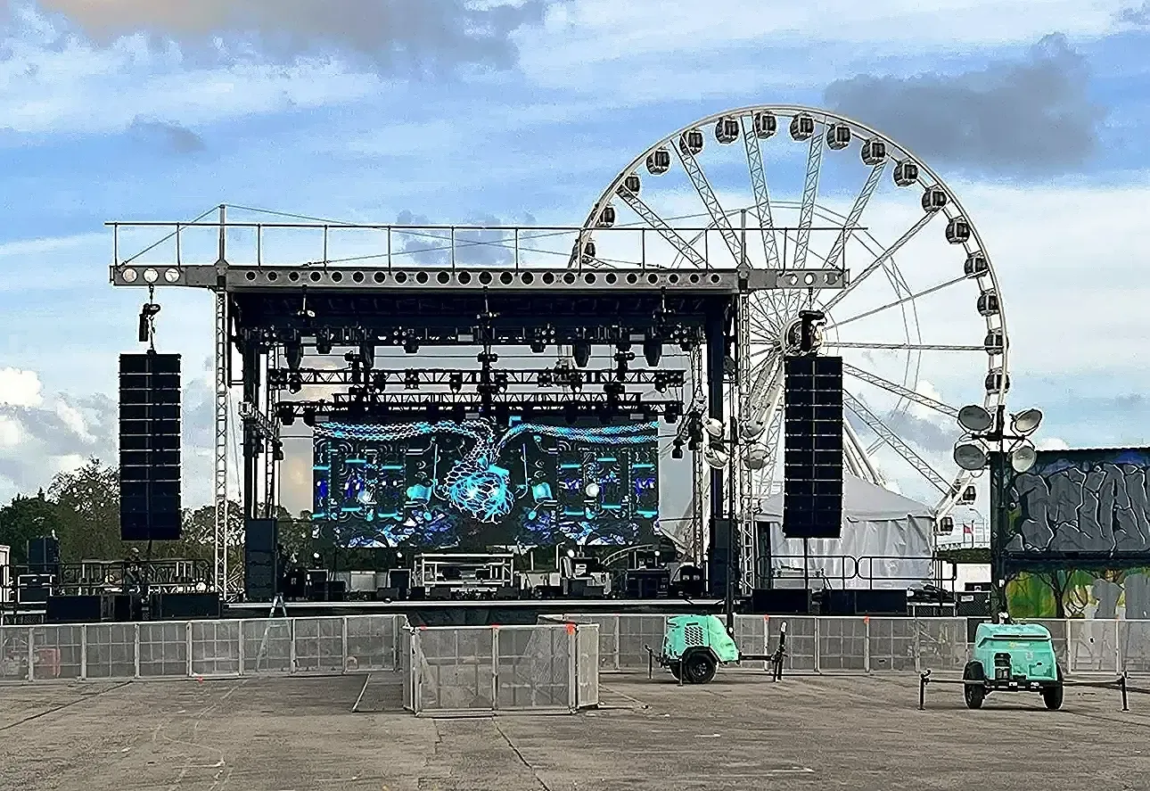 APEX 4240 stage built at a fairground with a ferris wheel behind it