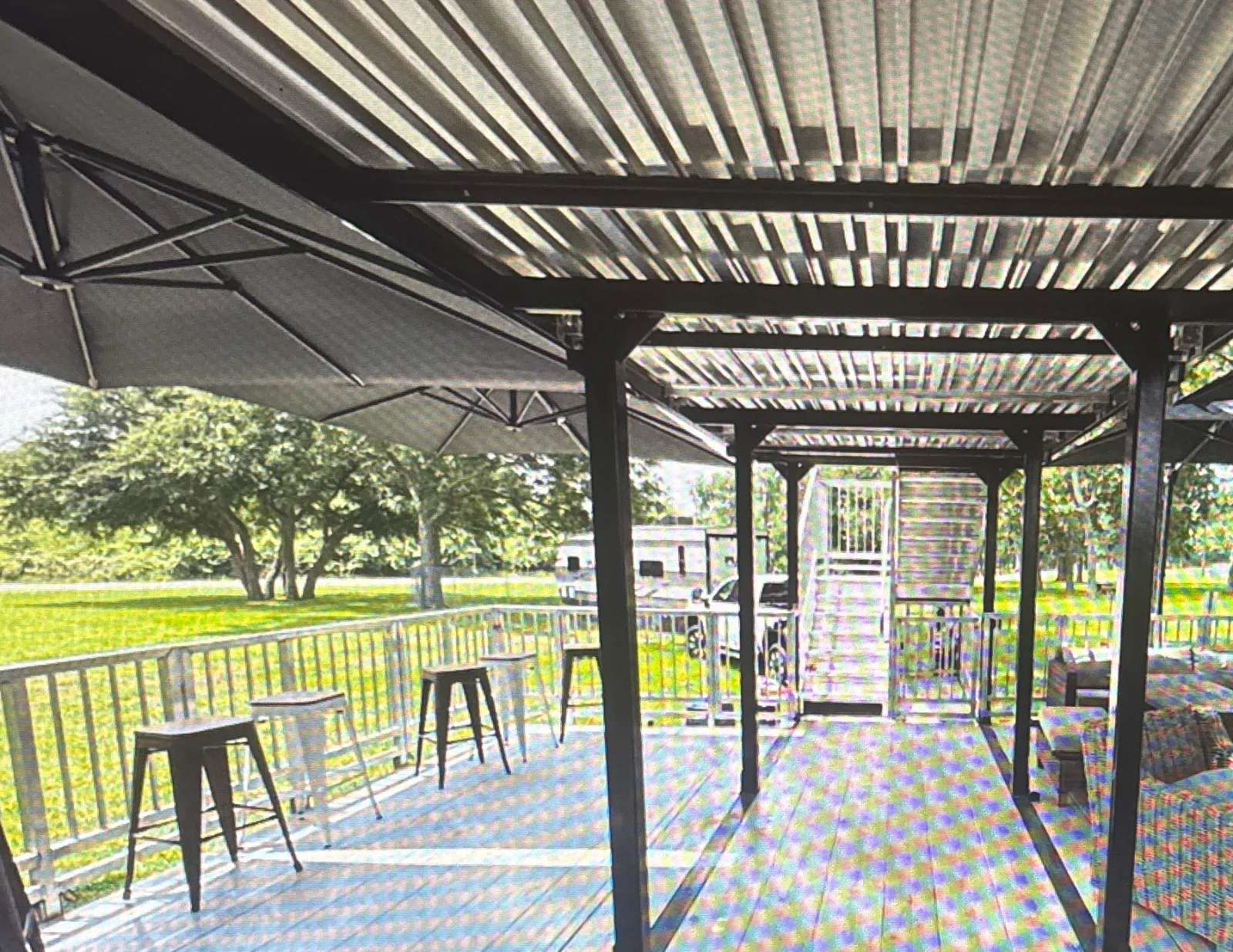 Lower deck of the The Nest VIP set up as a lounge with sofas, bar stools and shade